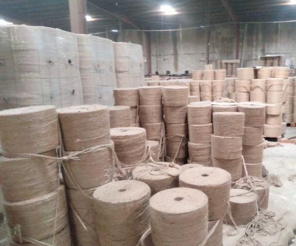 Bulk jute twine spools stacked in factory warehouse for export - Reliance International